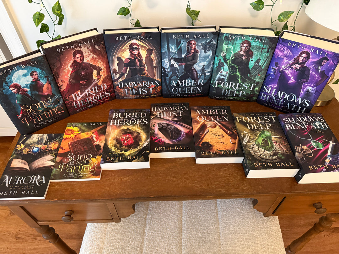 Collection of books by Beth Ball on a wooden surface with a neutral background